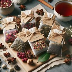 several bags of tea sitting on top of a cutting board next to an assortment of spices