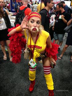 a woman dressed in yellow and red poses for the camera