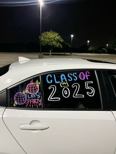 a white car with a class of 205 written on it's windshield at night