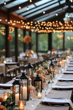 Elegant fall wedding tablescape with candle-lit lanterns, floral centerpieces, and twinkling string lights under a glass roof. Perfect autumn wedding ideas. Wedding Farm Decor, Modern Farm Wedding Decor, Chicago Fall Wedding, Fall Classic Wedding, Wedding Reception Unique Ideas, Fall Wedding Lights, Romantic Farm Wedding, Elegant Fall Wedding Ideas Romantic, Modern Fall Wedding Decor