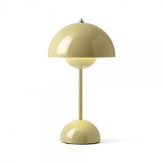 a yellow table lamp sitting on top of a white floor