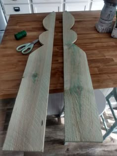 two pieces of wood sitting on top of a wooden table