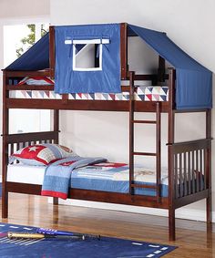 a bunk bed with a blue tent on top