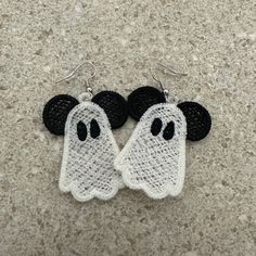 pair of black and white crochet ghost earrings with mickey mouse ears on them