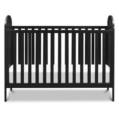 a black crib with white sheets on it