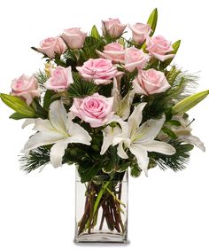 a vase filled with pink roses and white lilies