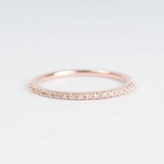 a rose gold wedding band with white diamonds