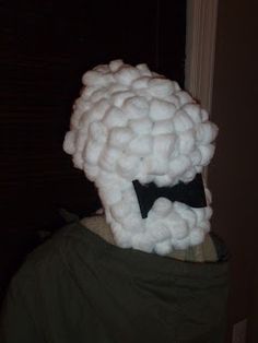 a person wearing a fake sheep's head with a bow tie around their neck