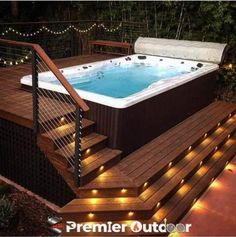 an outdoor hot tub with stairs and lights