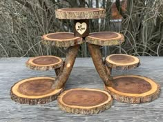 a wooden stand with several slices of wood stacked on top of each other in the shape of a heart