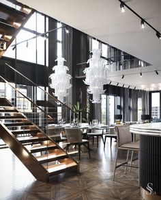 an elegant dining room with chandelier and stairs