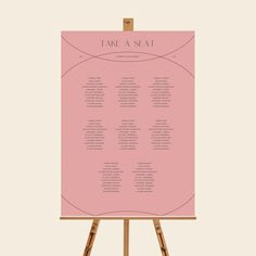 an easel with a seating chart on it and the words take me seat in pink