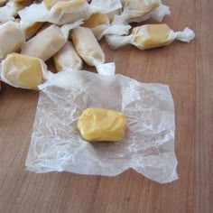 some food that is laying on top of wax paper and sitting on a wooden table