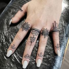 a woman's hand with some tattoos on it