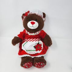 a brown teddy bear dressed in red and white