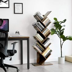 an office chair next to a desk with a bookshelf on it and a potted plant in the corner