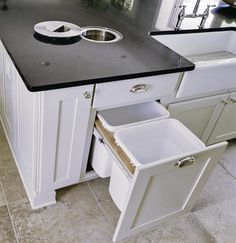 an image of a kitchen setting with sink and dishwasher in the center area