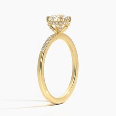 a yellow gold engagement ring with diamonds on it