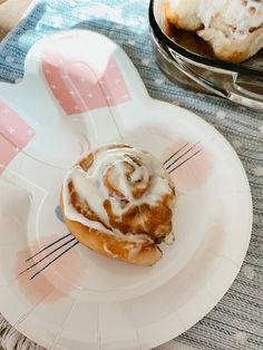 a cinnamon roll sitting on top of a white plate