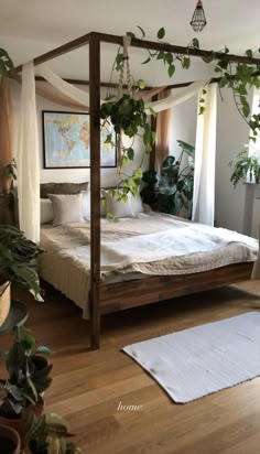 a bed sitting in the middle of a room with lots of plants on top of it