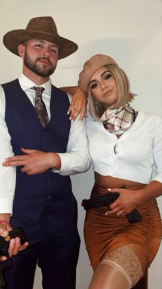 a man and woman are dressed up in costumes for the cameraman's photo shoot