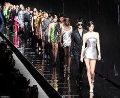 several models walk down the runway at fashion week