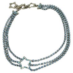 YVES SAINT LAURENT vintage silver tone star necklace embellished with blue crystals. T-bar and toggle closure. Embossed YSL Made in France. Indicative measurements : adjustable length from approx. 34.5 cm (13.58 inches) to approx. 38.5 cm (15.16 inches) / max. width approx. 2.2 cm (0.87 inch). Material : Silver tone metal hardware / Crystal. Good vintage condition (Grade : B). Wear consistent with age and use. A few crystals are less sparkling (need close inspection to be noticed). NOTES - This is a preloved vintage item, therefore it might have imperfections. - Colors may differ slightly from actual product appearance due to differences in lighting conditions. - As a buyer, you are fully responsible for customs duties, other local taxes and any administrative procedures related to imports