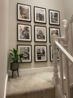 a staircase with pictures on the wall