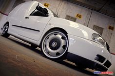 a white sports car parked in a garage