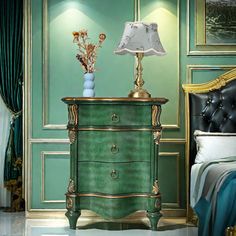 a bedroom scene with focus on the nightstand and bed in the foreground, along with an ornate green painted wall