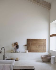 a kitchen with a sink, counter and wooden utensils