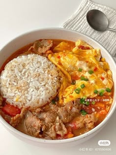 a white bowl filled with rice and meat