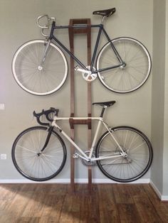 there is a bike mounted to the side of a wooden pole with two bikes on it