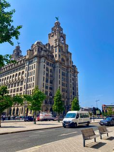 a very tall building with a clock on it's face in the middle of a city