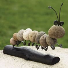 a group of stones sitting on top of a wooden stick