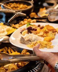 a person holding a plate with food on it