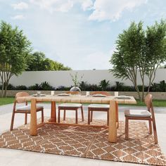 a table and chairs on a rug in the middle of a yard