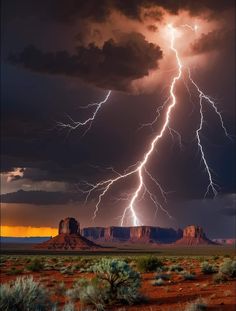 lightning strikes over the desert with mountains in the background