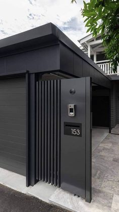 an open garage door in front of a building with two parking meters on the side