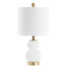 a white table lamp with a gold base and a white fabric shade on the top