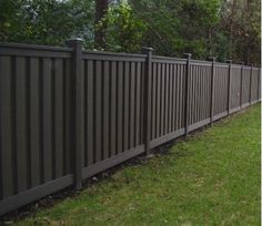 a fence in the middle of a grassy area