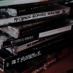 a stack of cds sitting on top of a wooden table