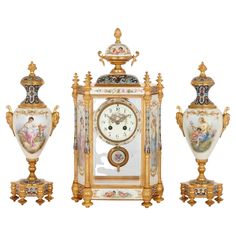 an ornately decorated clock and two vases