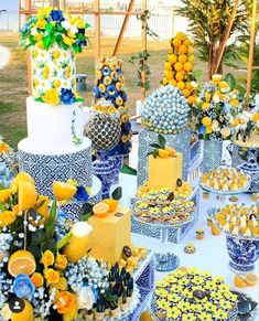 a table topped with lots of yellow and blue cakes