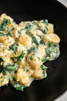 pasta with spinach and cheese in a skillet