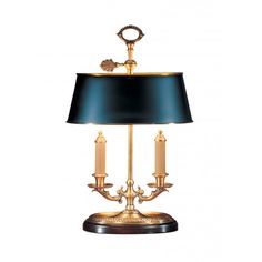 a table lamp with a black shade on top and two candles in the middle,