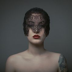 a woman's face is covered in lace