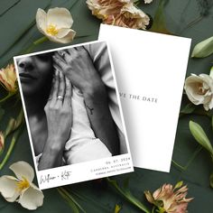 two wedding cards on top of flowers with the words save the date printed on them