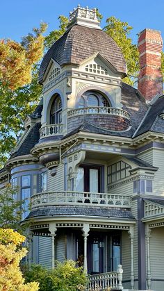 an old victorian style house in the fall