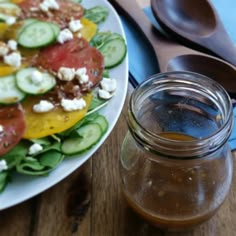 a salad with tomatoes, cucumbers and feta cheese in a mason jar